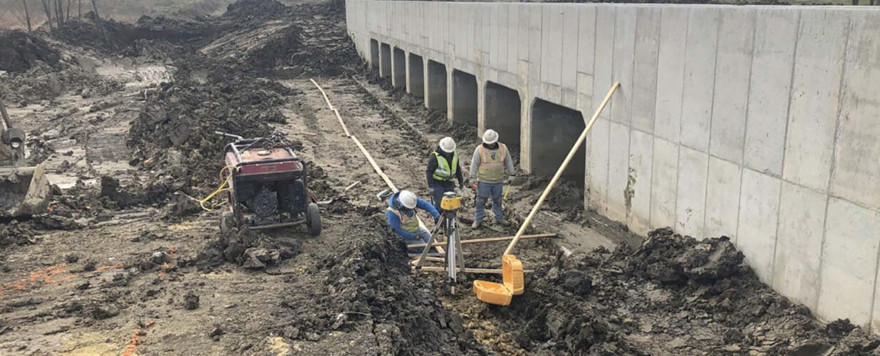 construction workers next to bridge on Dallas Parkway project