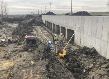 construction workers next to bridge on Dallas Parkway project