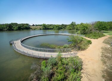 circular bridge walkway over Leander Lakewood Lake