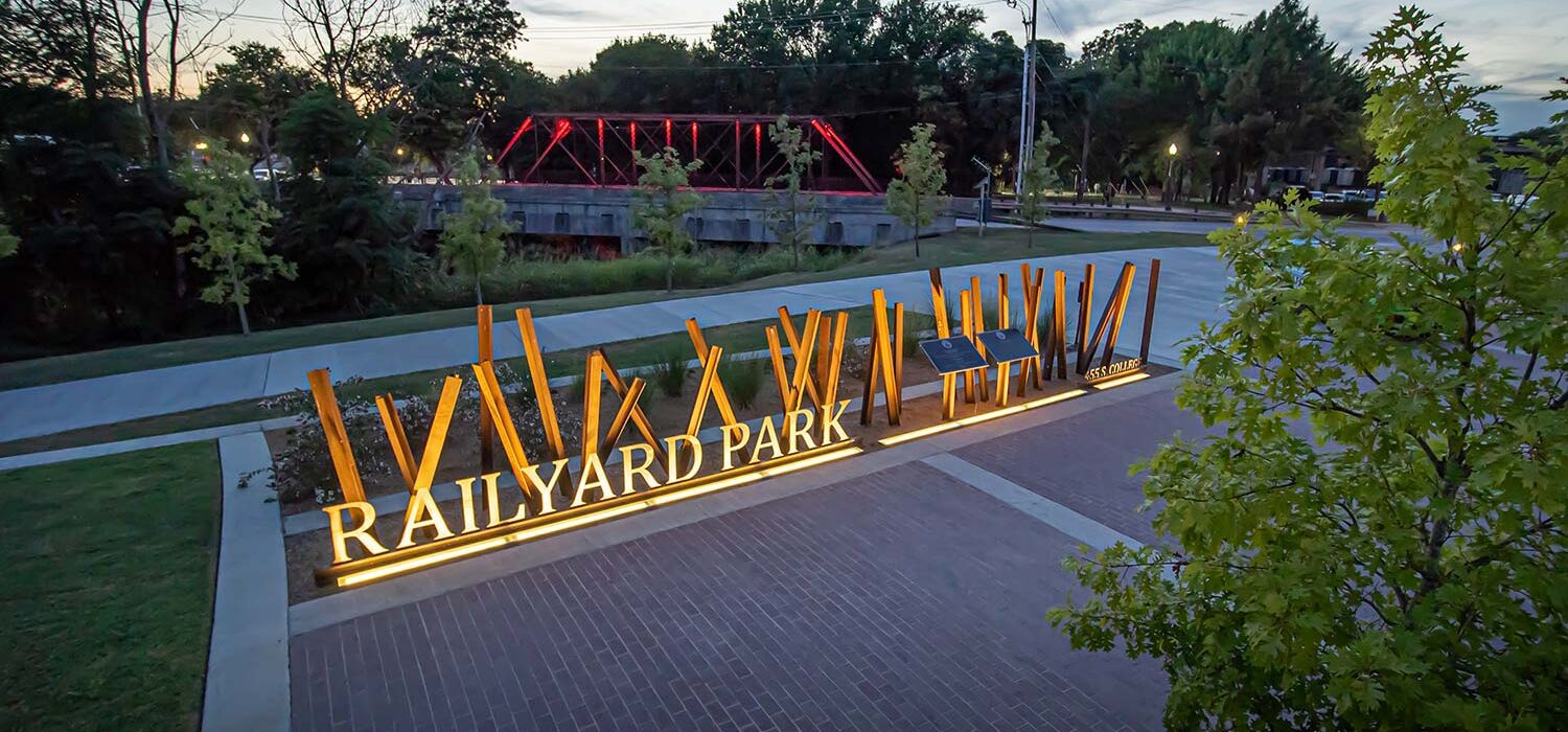 Railyard Park sign lit up in the evening