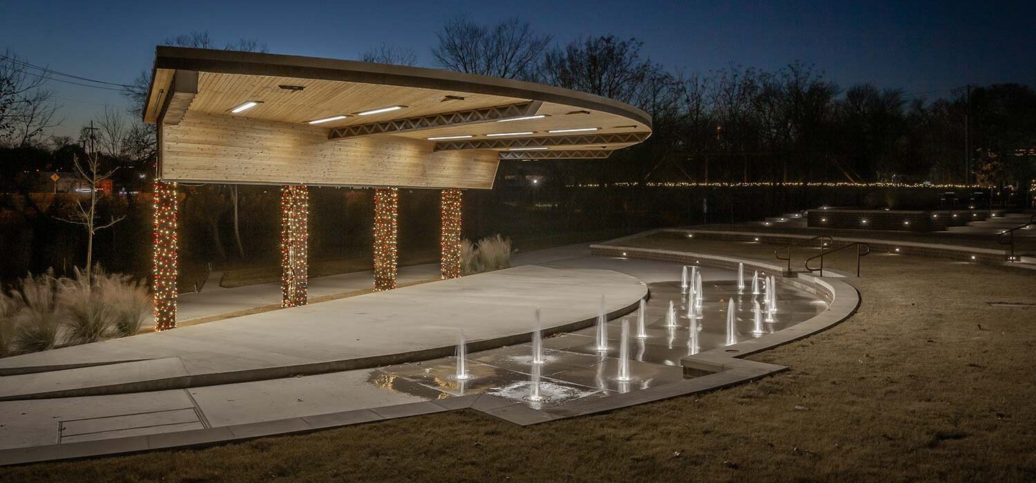 Waxahachie Amphitheater at night with Christmas lights and water feature
