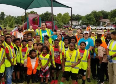 children and community wearing safety vests at Killeen Parks open space