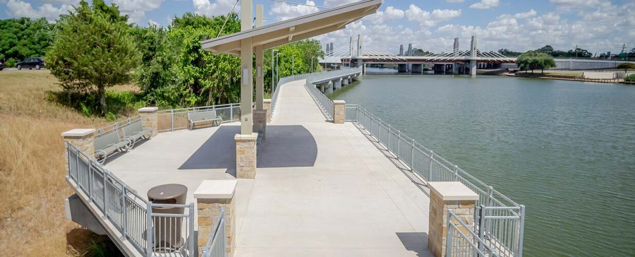 sidewalk trail with awning shade structure by the river at Waco Riverwalk