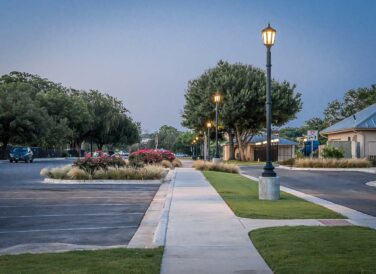 Marble Falls parking lot with street lights at dusk