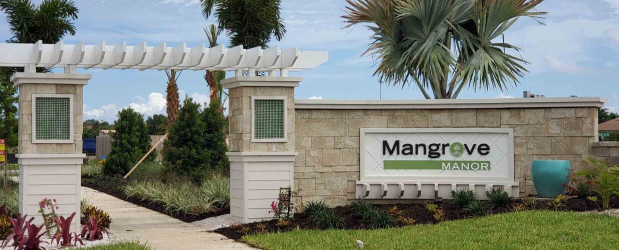 Mangrove Manor entrance sign with palm trees