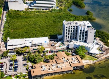 Wide aerial view of the Current Hotel next to the Tampa Bay