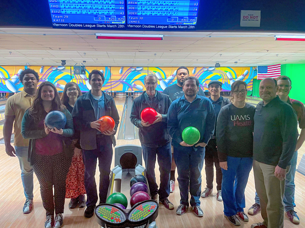 Little Rock employees smile at bowling alley