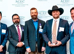 group of 5 Halff employees and attendees accepting 2023 ACEC Texas Engineering Excellence Award at gala