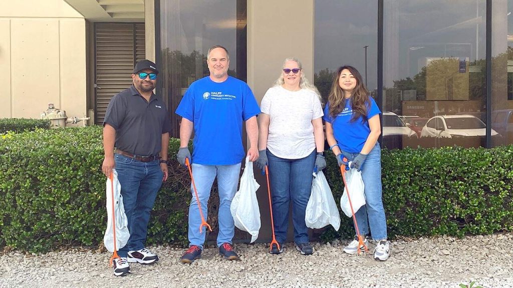 4 Richardson Halff employees picking up trash around the office outside