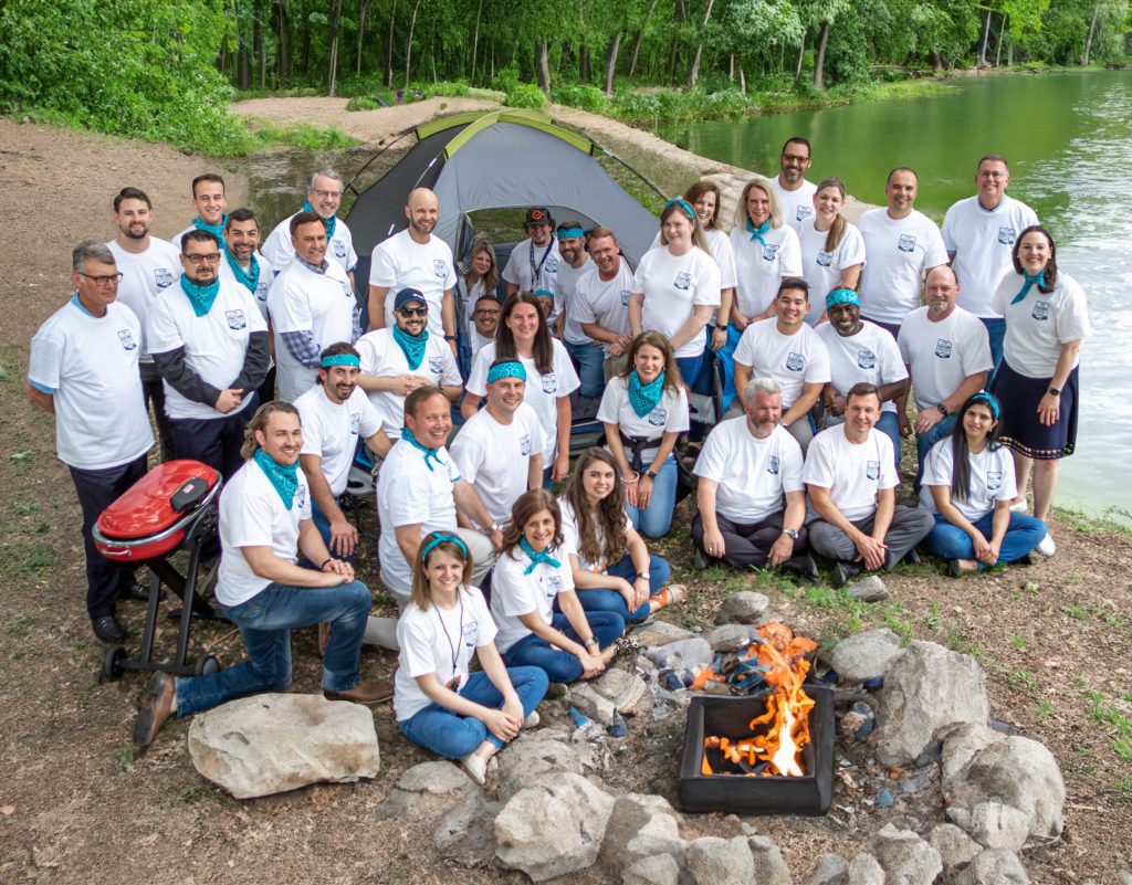 Group photo of Halff's Culture Camp Counselors by outdoor tent for 2023 summer cam sessions