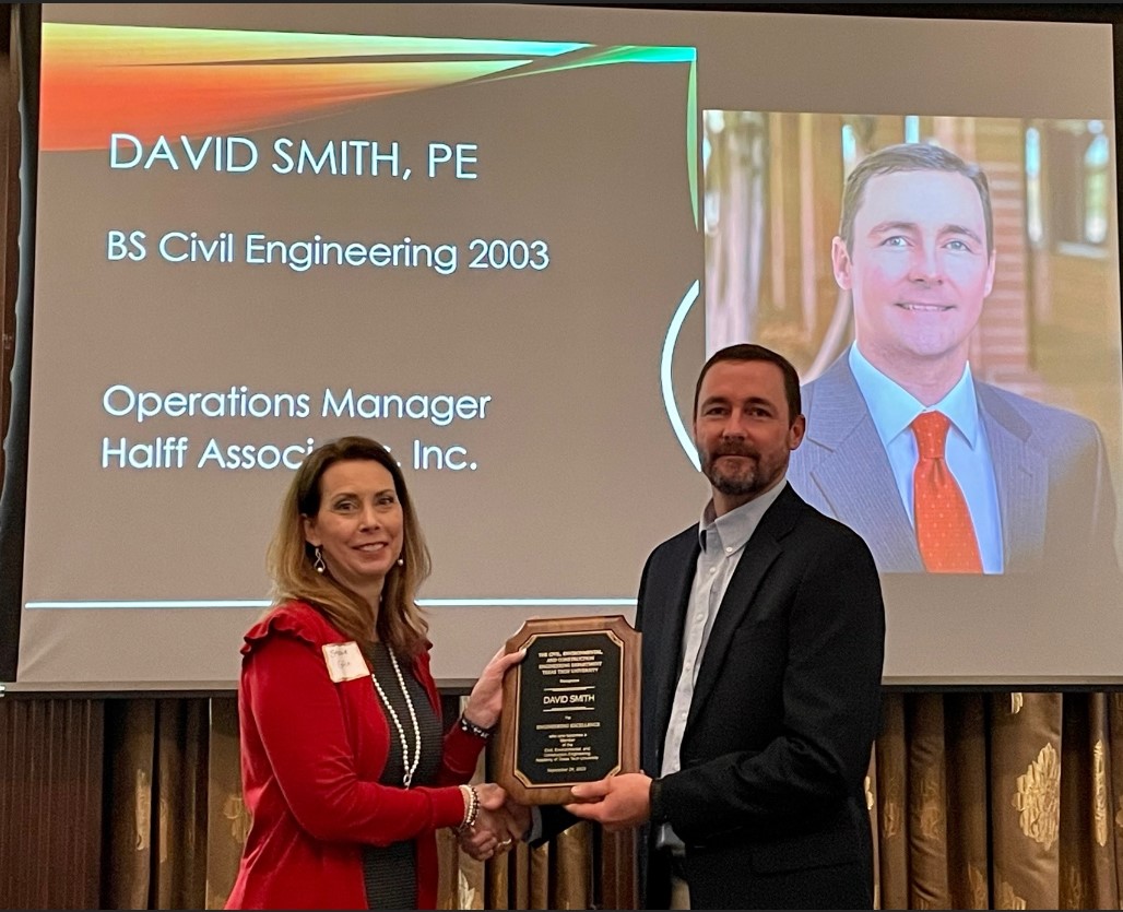 Halff's David Smith being presented the Academy plaque by Halff employee Stephanie Griffin