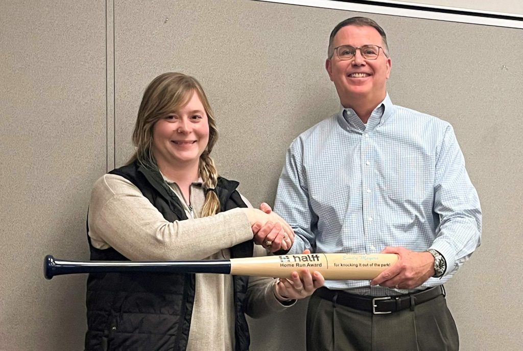 Halff President/CEO Mark Edwards presenting the Halff Home Run bat award to Project Manager Emily Acosta