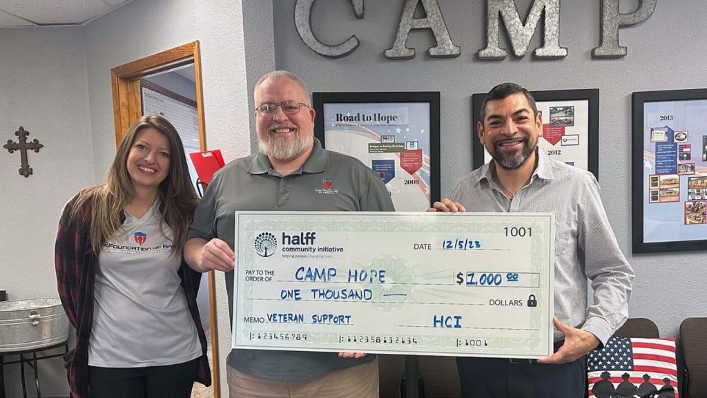 Erik Verduzco from Halff's Houston office presenting HCI's $1,000 check to Camp Hope
