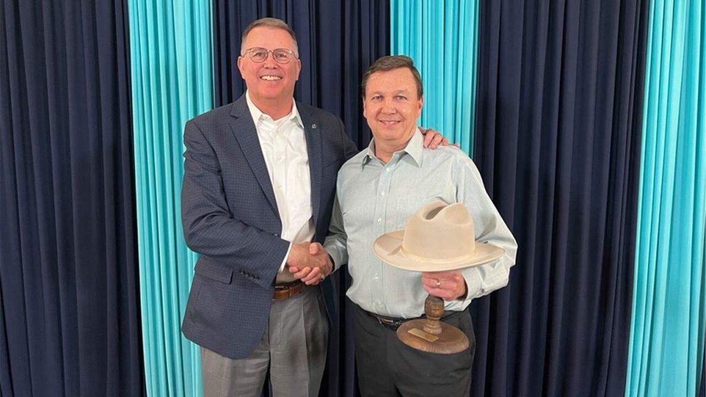 Retired President/CEO Mark Edwards presenting the Halff Stetson Hat Award to Russell Killen