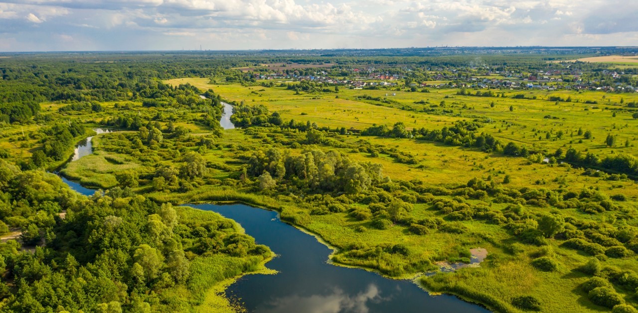 image of green open land with river running through WOTUS rules