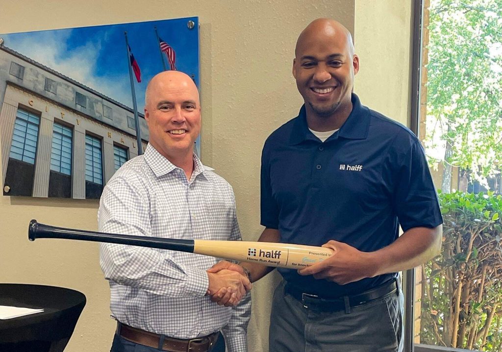 Civil Engineer Grant Russell receiving the Halff Home Run Award from Todd Jackson, Halff COO