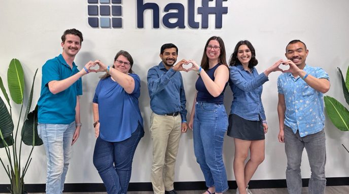 Austin South employees standing together making hearts with their hands to symbolize relationships