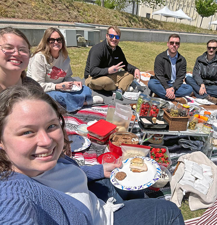 Bentonville, Arkansas office employees enjoing a pic outdoors for fun on Earth Day in 2024